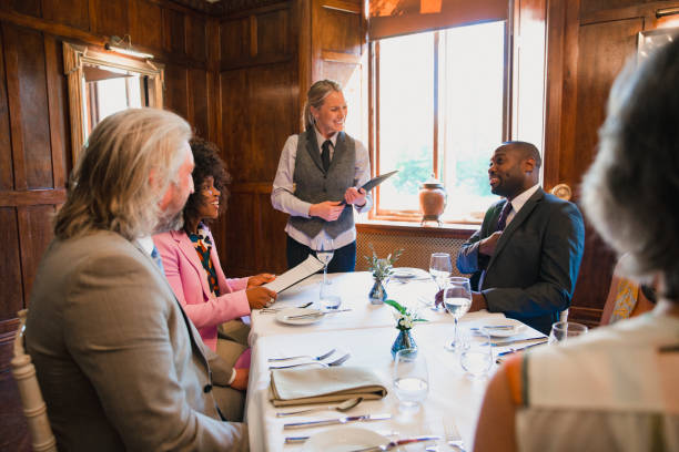 Group of well-dressed colleagues dining in a luxury restaurant