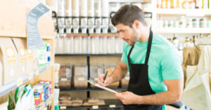 grocery store clerk taking inventory