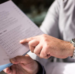 man pointing to dish on a restaurant menu during order